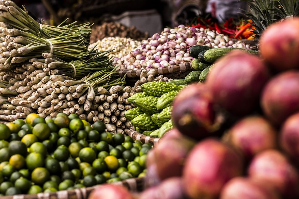 Fresh vegetables piled up at a market stall