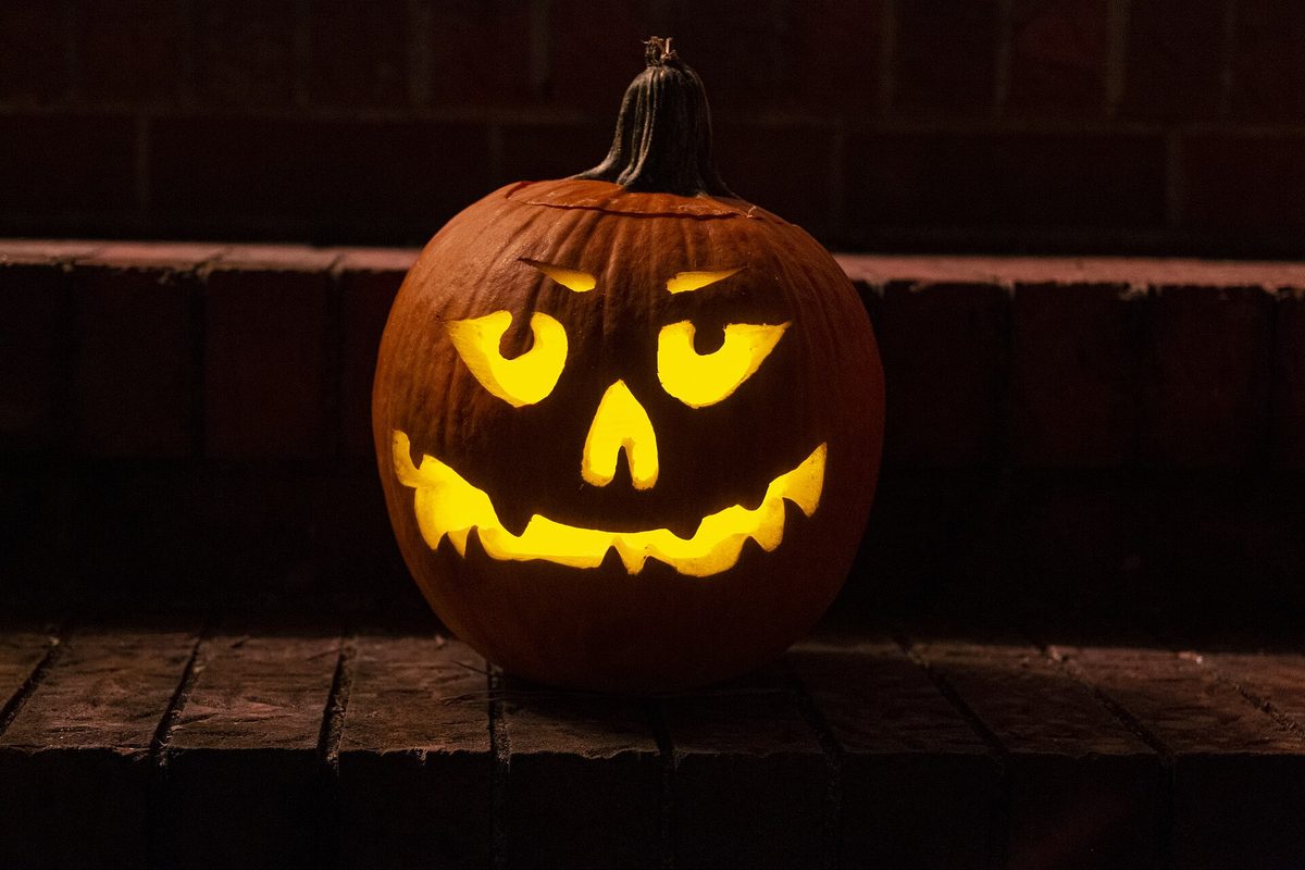 A carved jack-o-lantern glowing at night